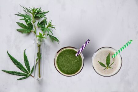 Concept edibles CBD and drinks with cannabis . Glasses with fresh beverage, milk and smoothies, with hemp. Flat layの写真素材