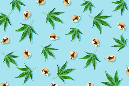 Christmas background, Christmas decor. Pattern of hemp leaves, cannabis and Christmas decorations on a blue backgroundの写真素材
