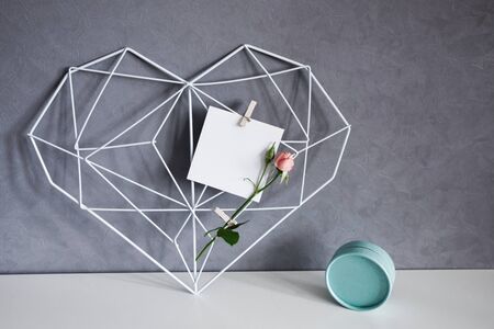 Graceful openwork heart with notes on a concrete wall background. Minimalism. Concept Symbol of love and Valentines Day. Home Decorの写真素材