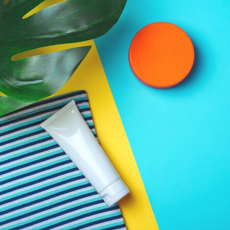 Sunprotection objects. Straw woman's hat with sun glasses and protection cream spf 30 top view on...