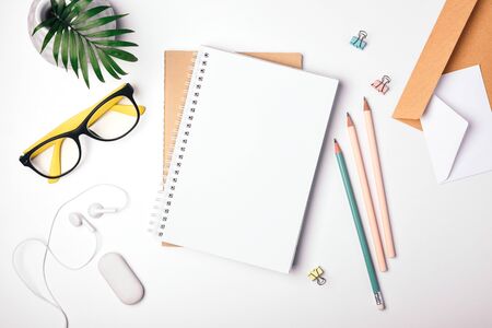 Freelancer workplace top view. Stay at home, work and study online. Notepad, stationery. Light background, flat layの写真素材