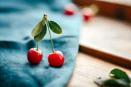 Ripe cherries close-up on a dark background. Selective focus. Good morning concept Rustic authenticity concept, vintage style.の写真素材