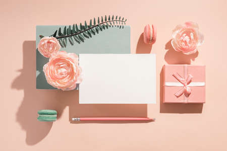 Festive mockup composition for greeting invitation, greeting card with flowers pastel colors, sunny shadows Congratulations on Womens Day and birthday. Romantic mockup concept for wedding invitationの写真素材