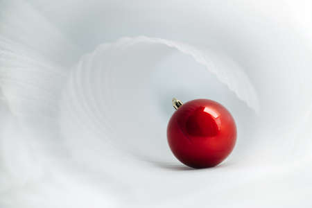 Beautiful minimalistic christmas background with red christmas ballの写真素材