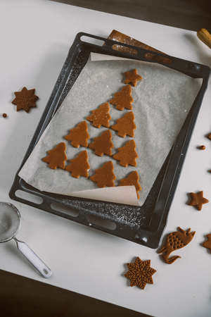 Lots of gingerbread cookies are laid out in shape of Christmas tree on parchmentの写真素材