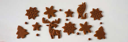 Pattern of Christmas gingerbread cookies in the form of animals, trees, snowflakes