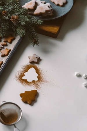 Kitchen table with gingerbread cookies and christmas decor, christmas treeの写真素材