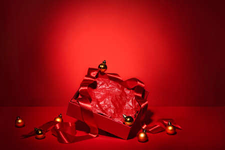 Blank open red gift box with ribbon and Christmas decor.の写真素材