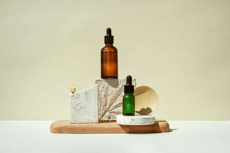 CBD oil, cannabis setting in different bottles in a still life on geometric podiumの写真素材