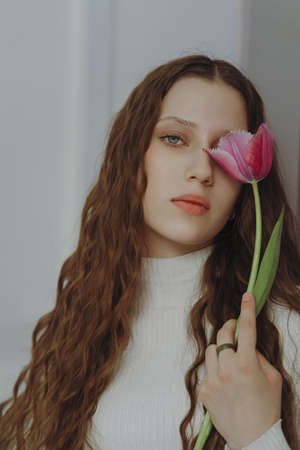 Portrait of young girl, long hair with flowerの写真素材