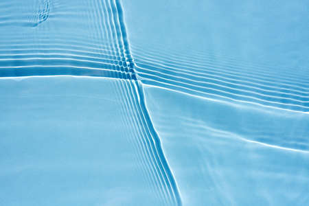 Beautiful oncoming waves, ripples on clear water, blue background