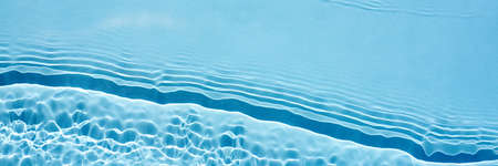 Background, texture of transparent blue water with seething ripples , wavesの写真素材