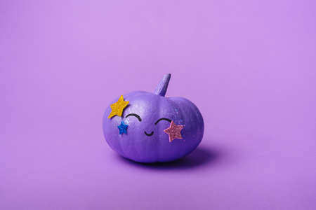 Beautiful purple pumpkin with a shiny disco make-up. Halloween holiday background conceptの写真素材