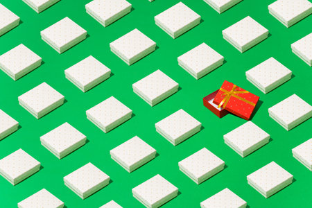 Trendy pattern, an ornament of white gift boxes on a green backgroundの写真素材