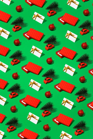Minimal pattern of Christmas symbols, cars, gifts, Christmas trees, bonus card, green background.の写真素材