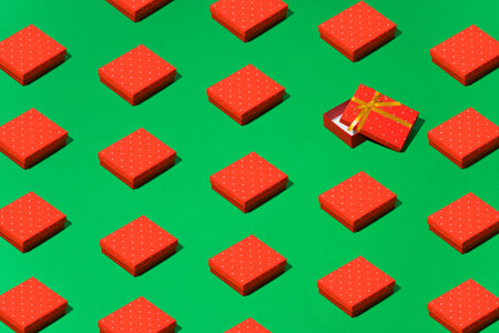 Geometric pattern, an ornament of red gift boxes on a green backgroundの写真素材