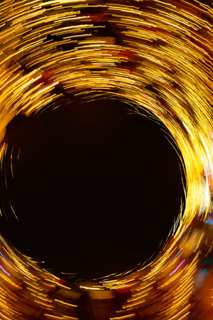 Abstract round texture of golden neon lights in motion, black empty copy space