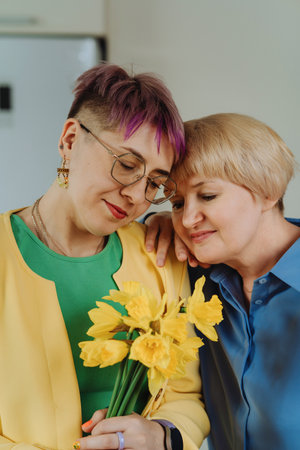 Daughters Warm Hug and Floral Present on Mothers Day, Womens Day