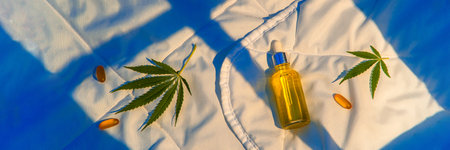 Products on insomnia blanket, cannabis oil tincture, CBD, marijuana leafの写真素材