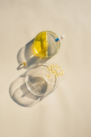 Petri dishes with transparent oil, serum, capsules Skin care, cosmetic essence, serum for Hydration. Skin care background with vitamins Collagen and vitamin C for beautiful skin, Hydration cosmeticsの写真素材