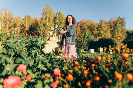 Woman gardener embracing the beauty of nature on her sustainable homestead. Plant lover in her element: enjoying the beauty of nature and sustainability on her landの写真素材