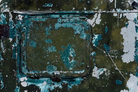 Distressed rusty metal plate with peeling green paint and corroded surface. Perfect for military, vintage, industrial design and overlaysの写真素材