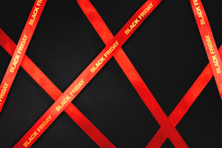 Black Friday sale background with red satin ribbons and diagonal layout Elegant red ribbon...