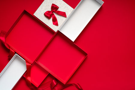 Clean red background with gift boxes and ribbons, ready for product showcase, sale banner or social...