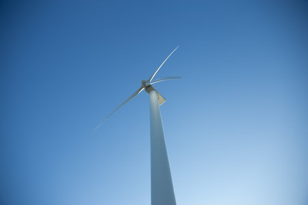 An image of windturbine generator against a clear blue skyの写真素材