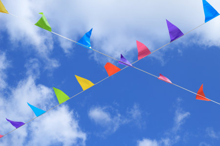 The view on the colorful small  decorative flags waving on the windの写真素材