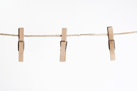 three clamps for laundry hanging on a stringの写真素材