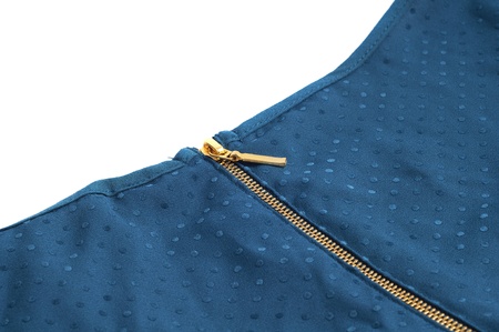 golden zipper on a blue garment