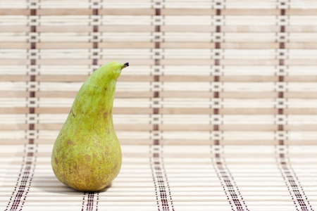 green pear on a wooden backgroundの写真素材