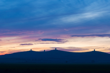 Mountain range silhouette at sunset with colorful skyの写真素材