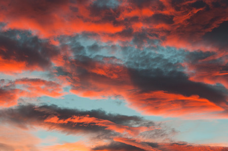 Fantastic red clouds in blue sky during sunset
