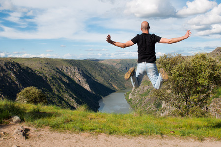 Young man jumping. Arribes del Duero river natural parkの写真素材