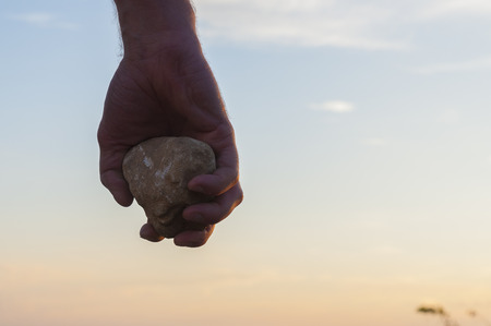 Hand holding a stone. の写真素材
