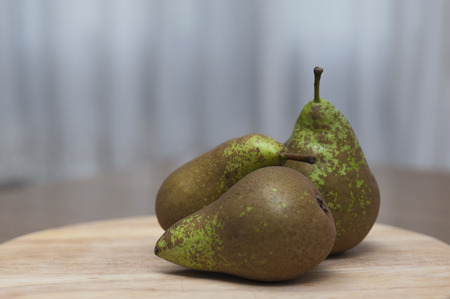 Green pears on wooden table の写真素材