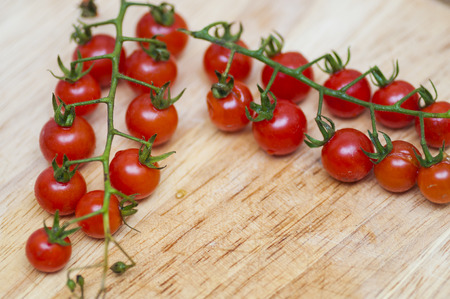 Some red cherry tomatoes in wooden の写真素材