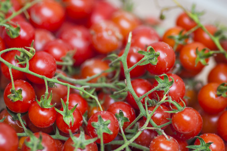Some red cherry tomatoes in wooden の写真素材