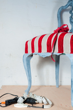 Upholstery work. Wooden chair painted with beautiful fabricの写真素材