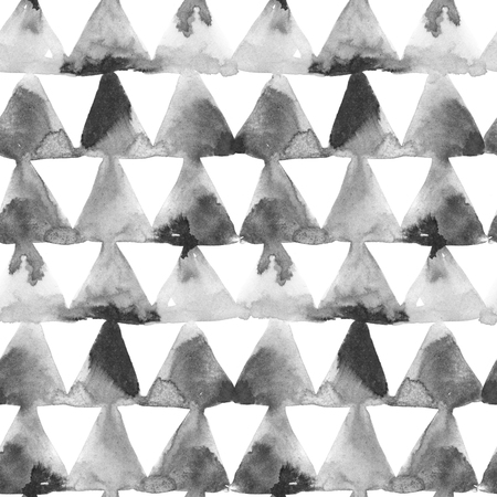 Geometric ornament of ink painting triangles on white background. Watercolor seamless pattern.の写真素材