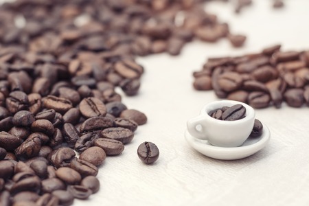 Coffee beans and toy cup with coffee, concept, copy spaceの写真素材