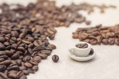 Coffee beans and toy cup with coffee, concept, copy spaceの写真素材