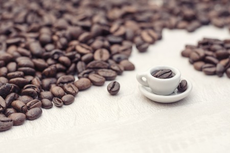 Coffee beans and toy cup with coffee, concept, copy spaceの写真素材