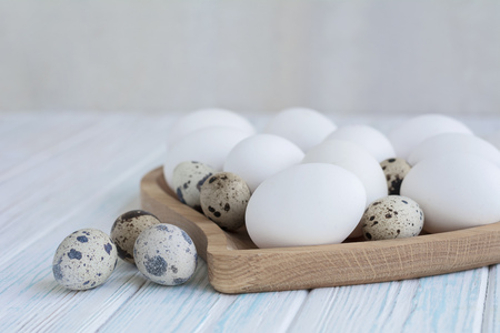 Quail eggs on a plate with heart-shaped closeup on rustic table. Easter food. Space for your textの写真素材