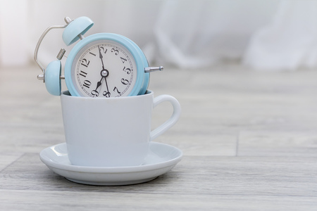 vintage alarm clock on solid light grey color background