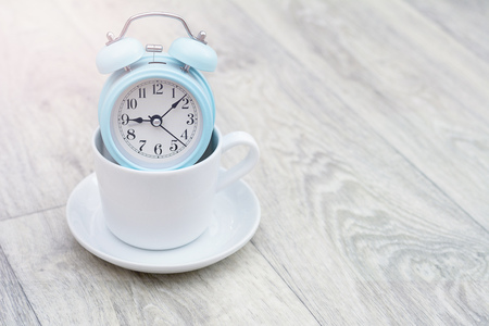vintage alarm clock on solid light grey color backgroundの写真素材