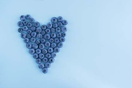 Blueberies heart on blue background, textureの写真素材