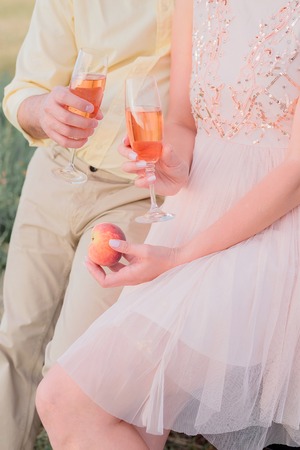 Cropped shot of man and woman holding champagne into the glass in their hands, celebrating conceptの写真素材